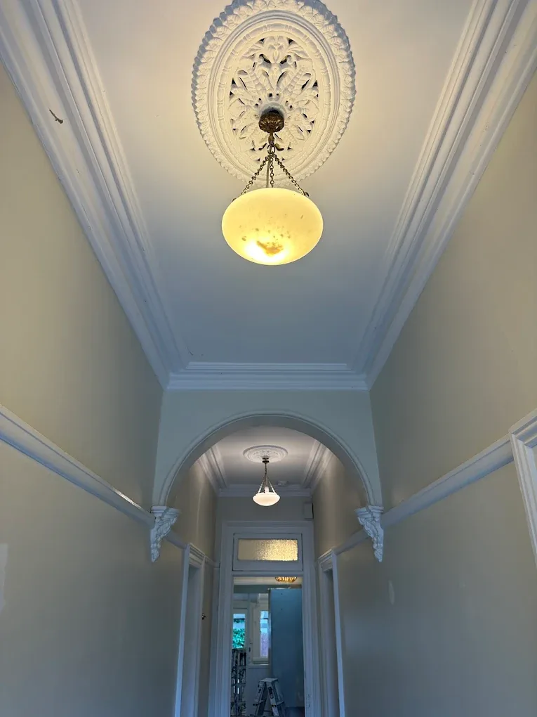 Restored ornate ceiling rose with pendant light