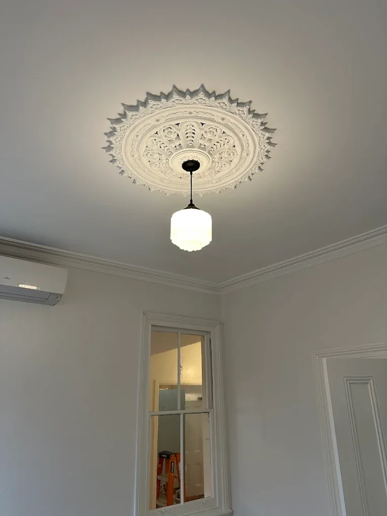 Ornate ceiling rose with restored deco pendant light