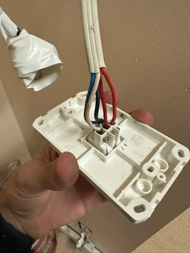 Light fixture base being wired in