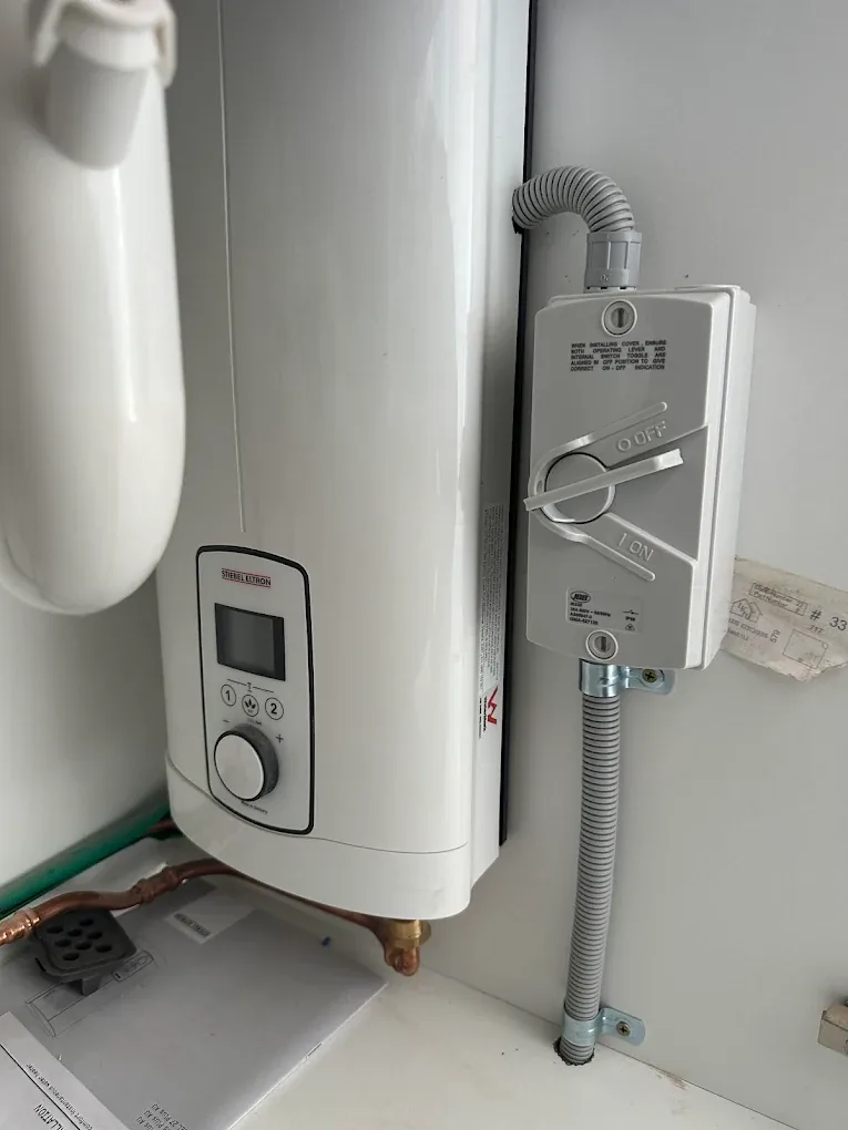 Hot water system isolator switch installed