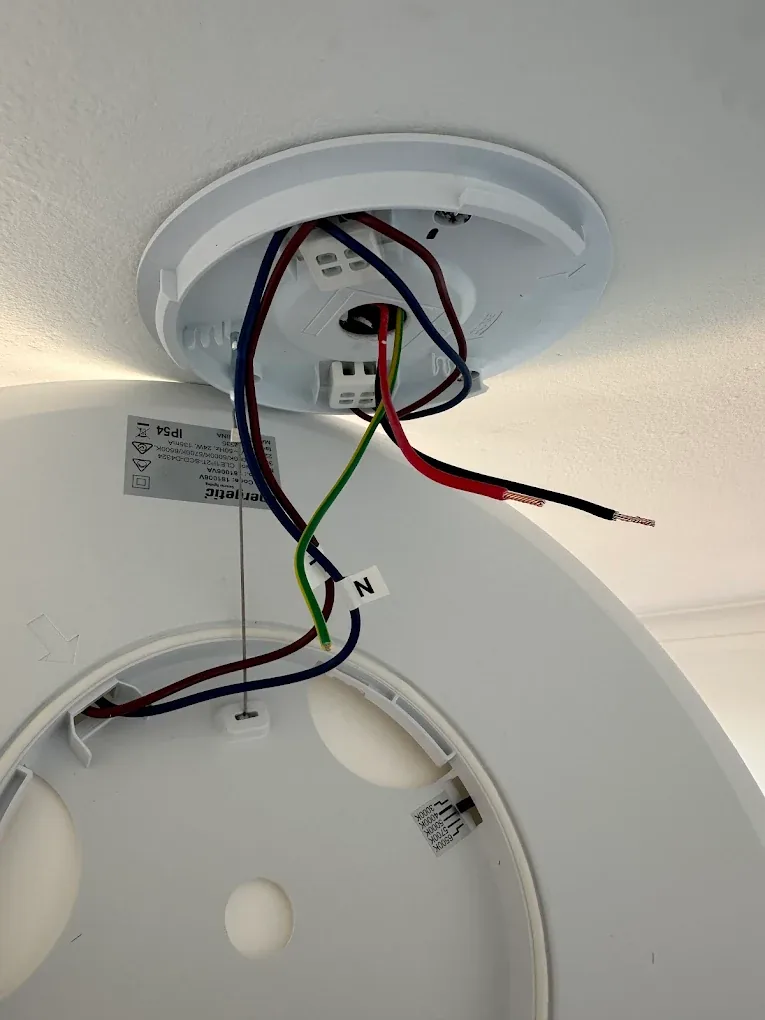 Oyster light being wired on ceiling